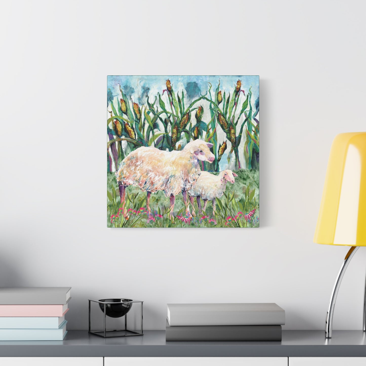 Canvas print of two sheep in a field with corn on a wall above a desk.