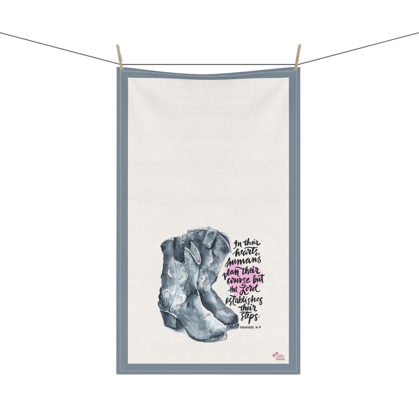 Kitchen tea towel with cowboy boots and Bible verse "In their hearts humans plan their course but the Lord establishes  on a white backgroundheir steps" 