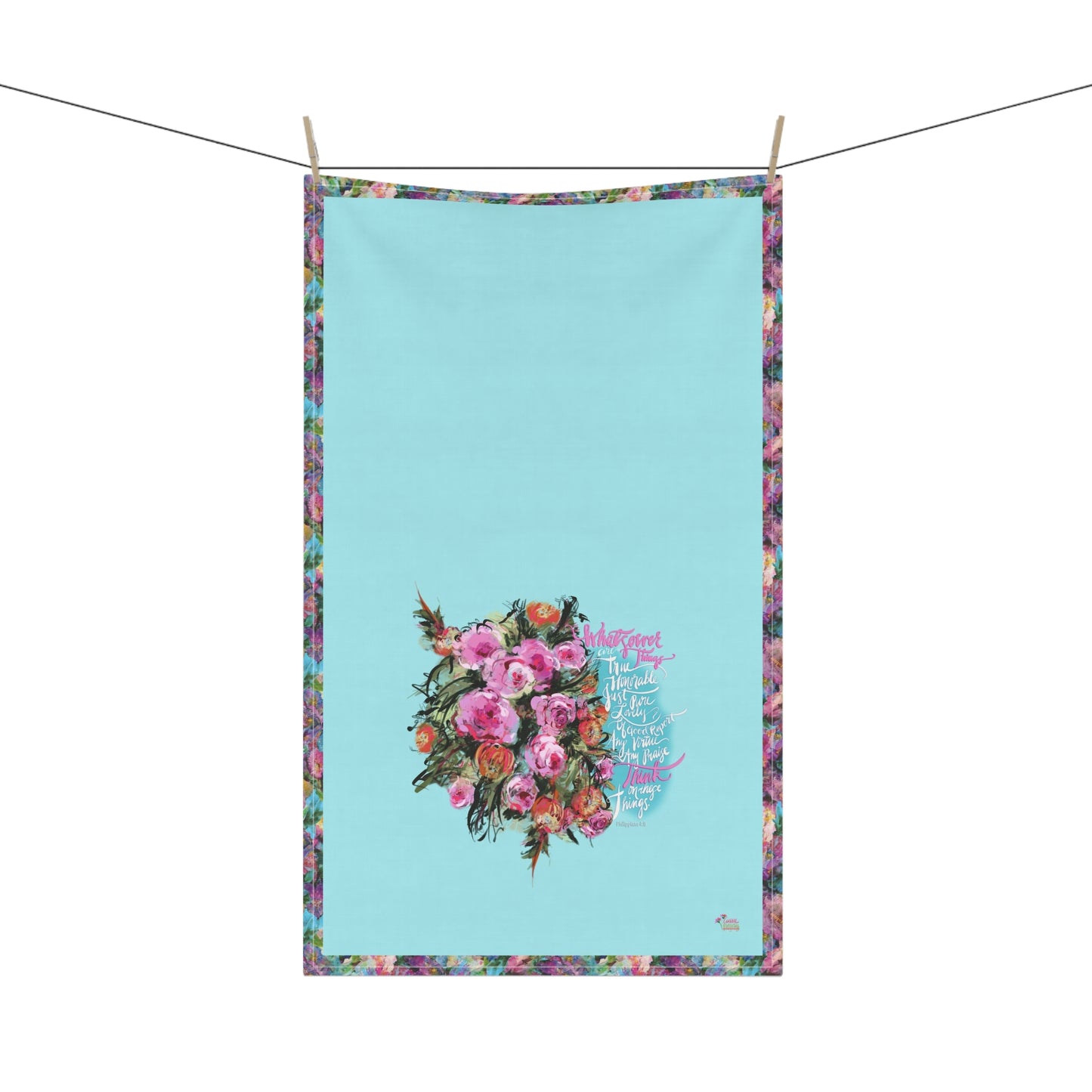 Floral kitchen towel with calligraphy Bible verse "Whatsoever things" on a blue background, hanging on a line.