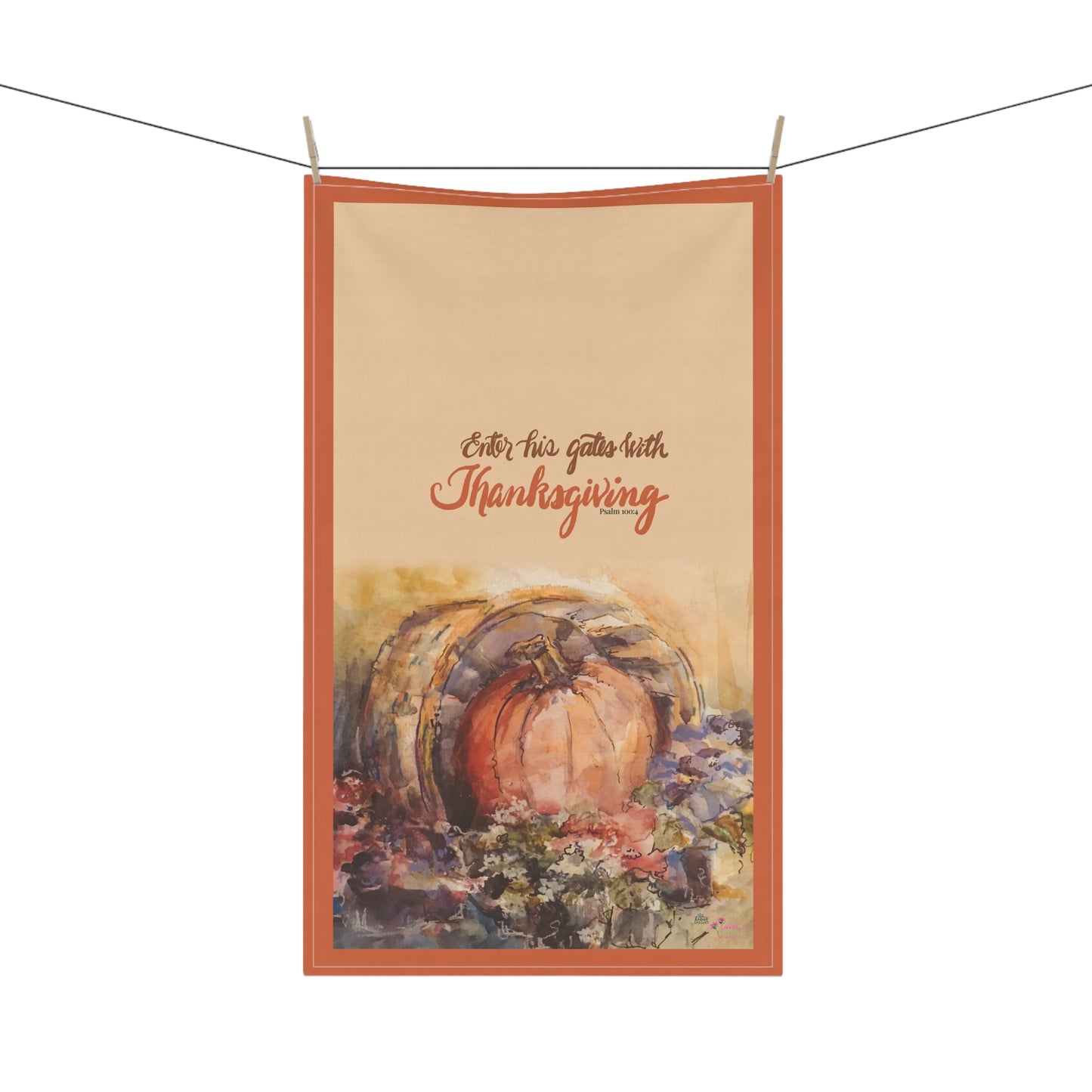 Decorative kitchen towel with pumpkin and Bible verse text 'Enter his gates with thanksgiving' on a white background