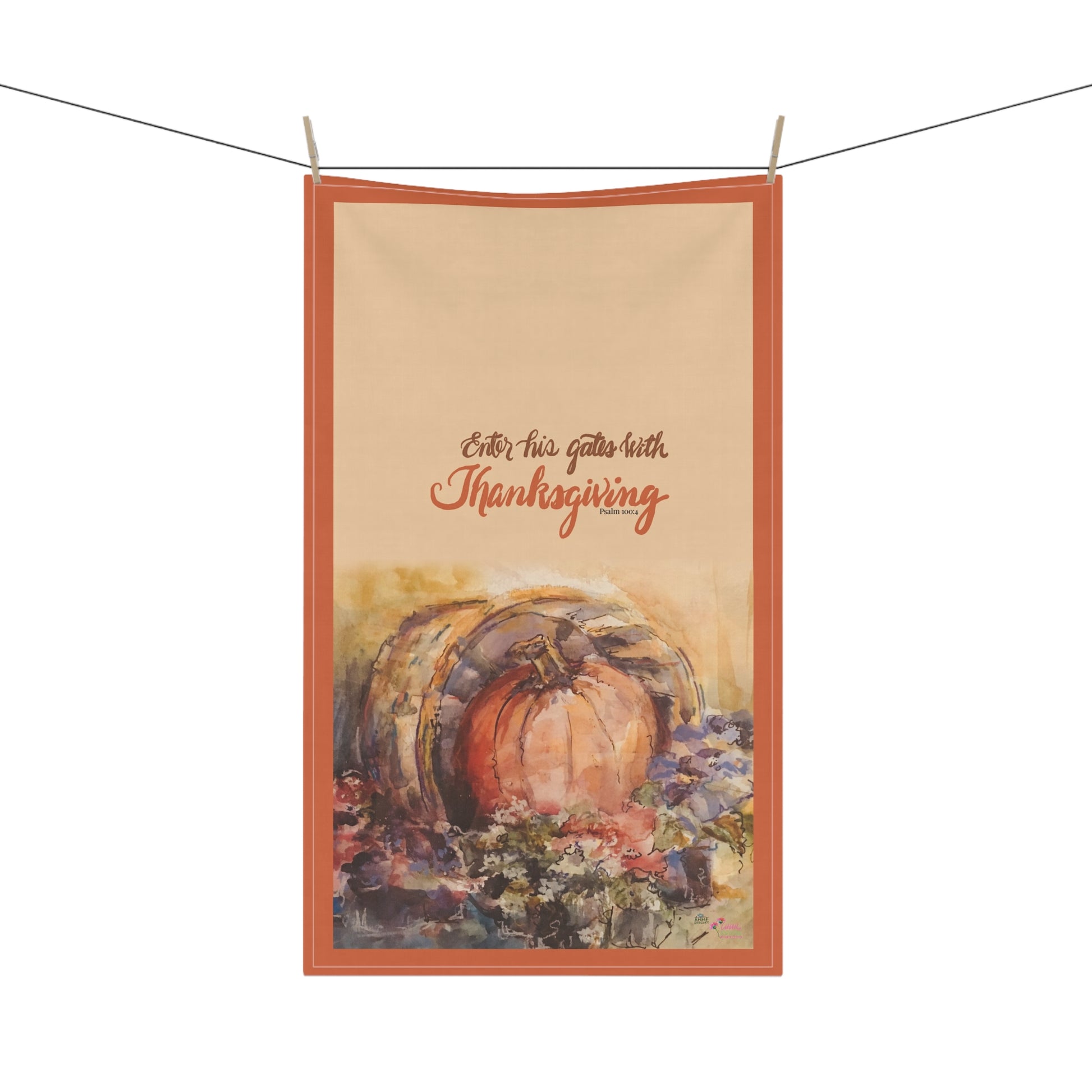 Decorative kitchen towel with pumpkin and Bible verse text 'Enter his gates with thanksgiving' on a white background
