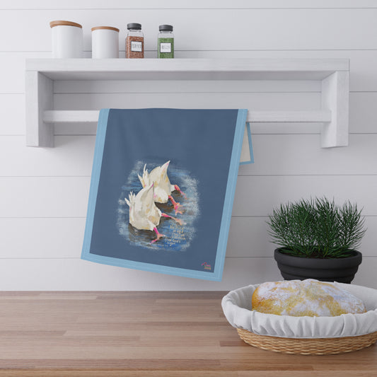 Kitchen towel with two ducks in water design and Bible verse "Nothing is hidden" hanging on a wooden shelf with kitchen items.