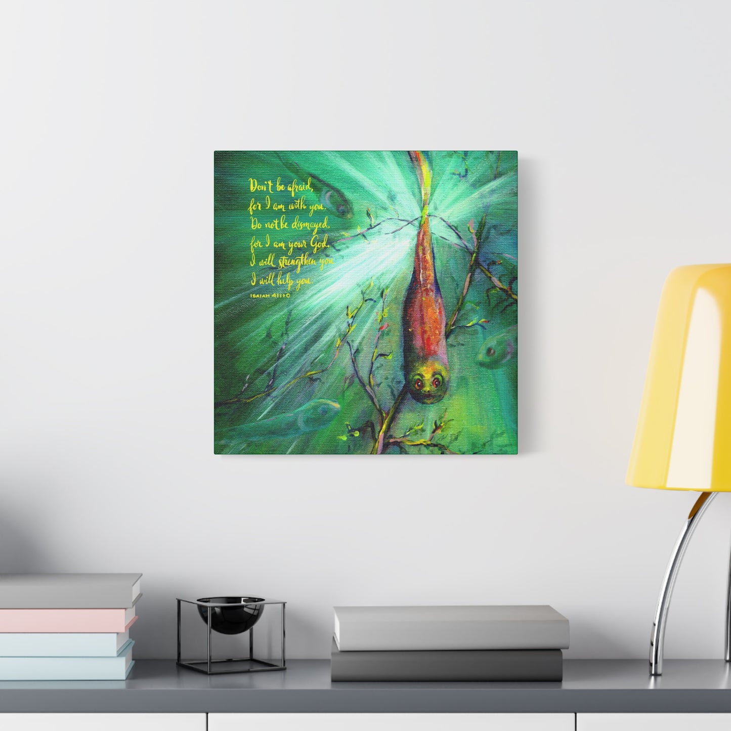 Canvas artwork of a tadpole with a green background and Bible verse text Do Not Be Afraid on a wall above a shelf.