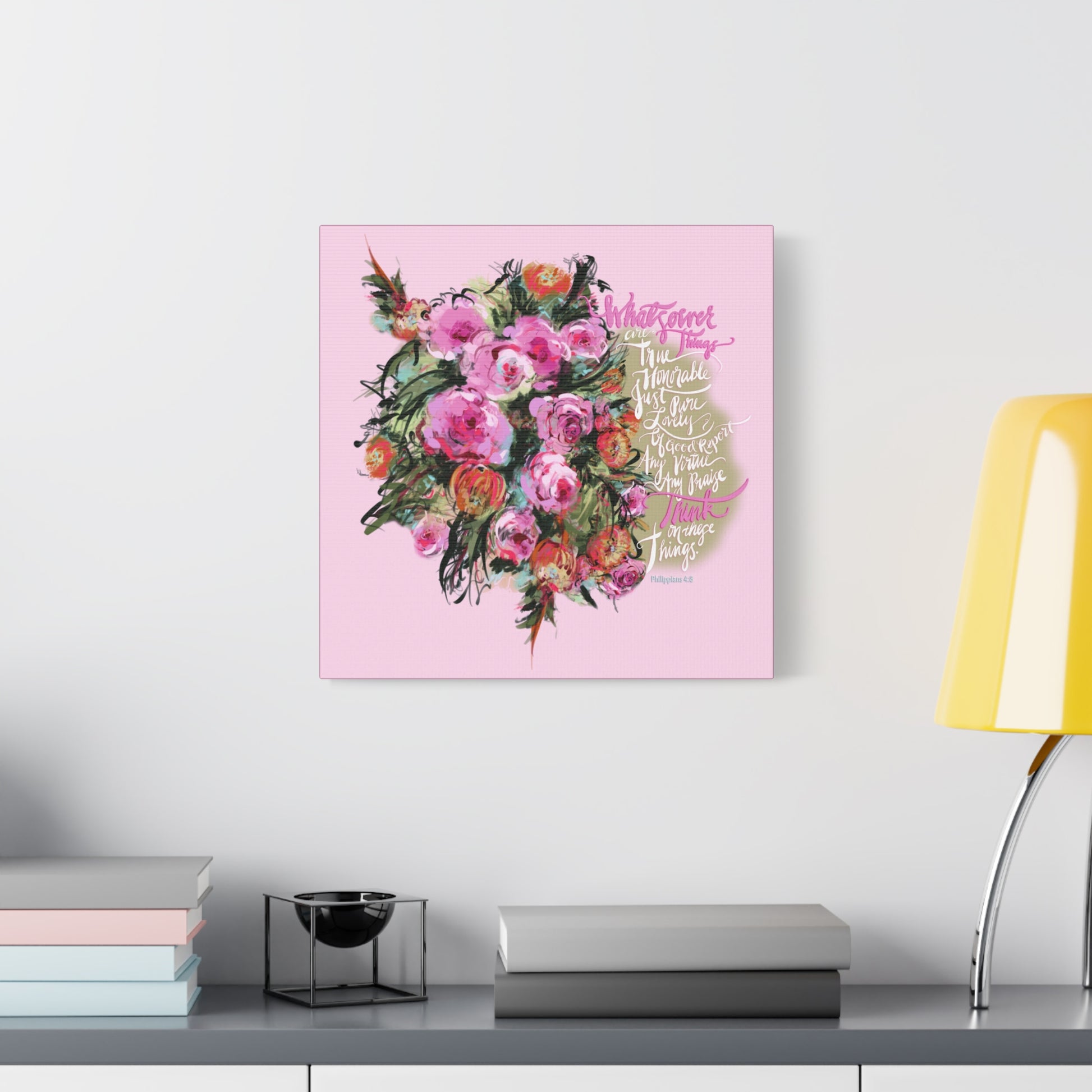 Floral artwork with Bible verse, Whatsoever Things,  on a pink background above a desk with books and a lamp.