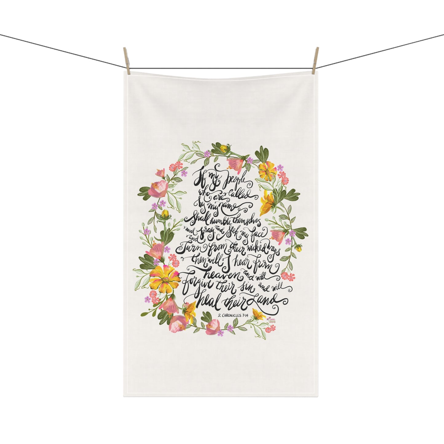 White towel with floral design and calligraphy Bible verse If My People; on a white background